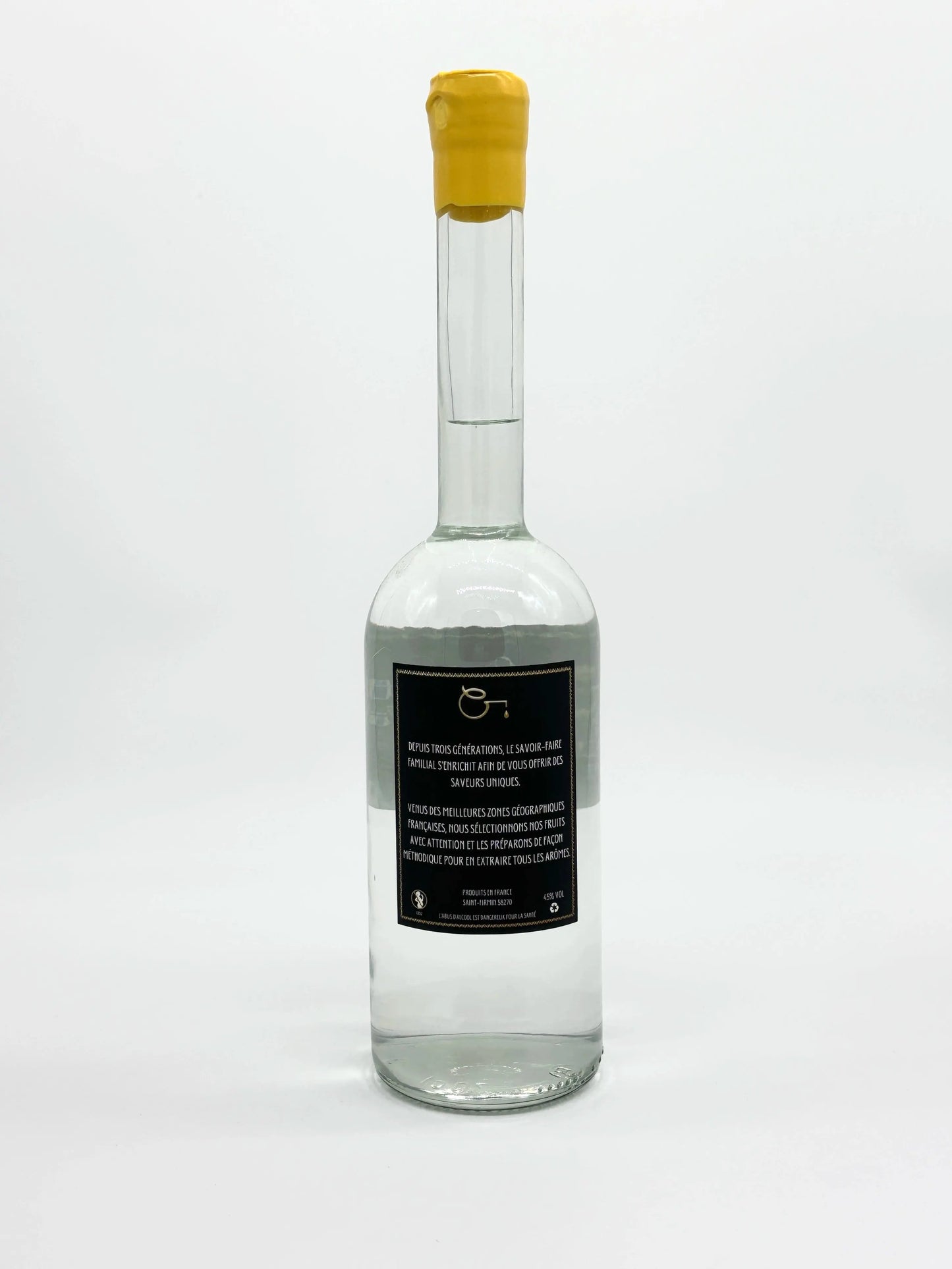 Étiquette arrière de la bouteille d’eau-de-vie de mirabelle La Goutte du Fils, 70cl, bouchon jaune, sur fond blanc